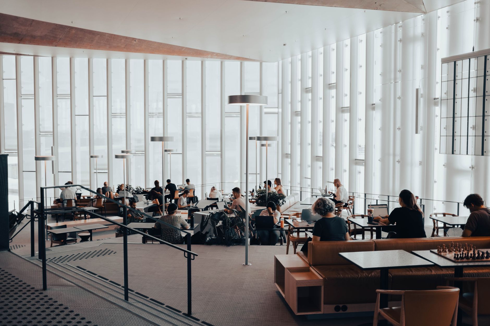 People socialising inside a modern British public library, one of the UK's key third places in 2026